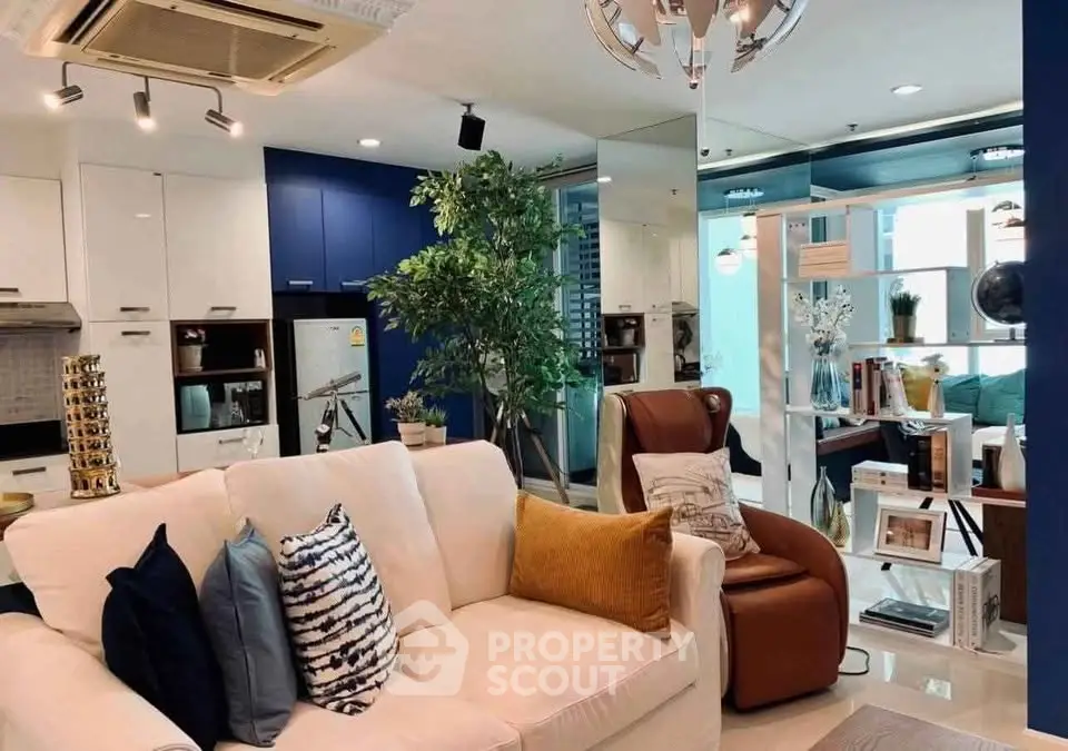Modern living room with stylish decor and open layout, featuring cozy seating and vibrant accents.