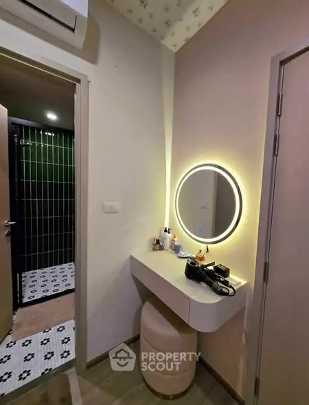 Stylish vanity area with illuminated mirror and modern decor