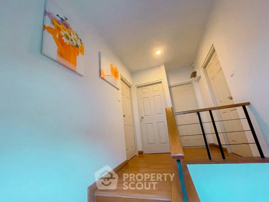 Bright hallway with wooden flooring and modern decor in a stylish home