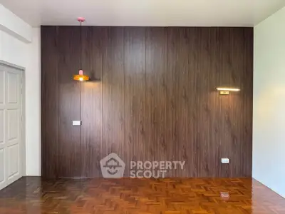 Elegant living room with wood panel accent wall and parquet flooring