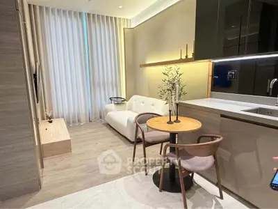 Modern living room with open kitchen, featuring sleek furniture and ambient lighting.