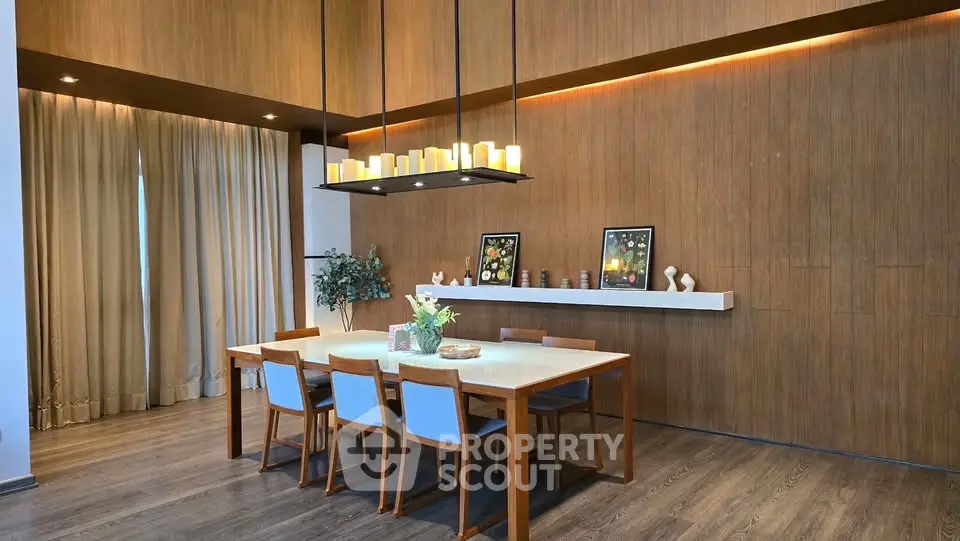 Elegant dining room with modern lighting and wooden accents