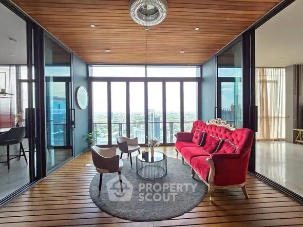 Luxurious living room with stunning city view and elegant red sofa