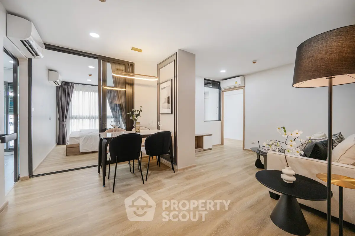 Modern open-plan living and dining area with stylish decor and natural light.