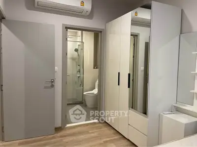 Modern bedroom with ensuite bathroom and sleek wardrobe design