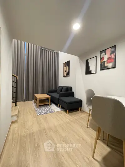 Modern living room with stylish decor and cozy seating area in a contemporary apartment.