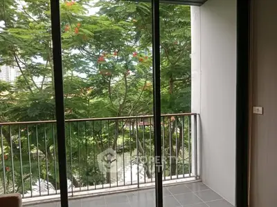 Charming balcony with lush green view, perfect for relaxation and enjoying nature.