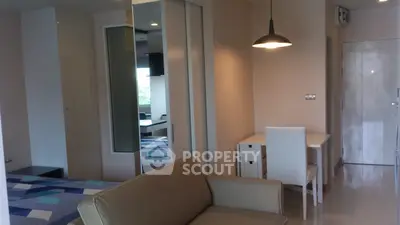 Modern studio apartment with stylish decor and cozy seating area