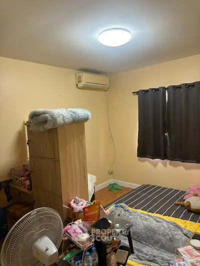 Cozy bedroom with air conditioning and modern furnishings, perfect for comfortable living.