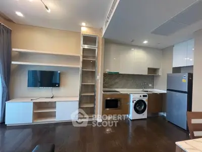 Modern kitchen and living area with built-in appliances and sleek design.