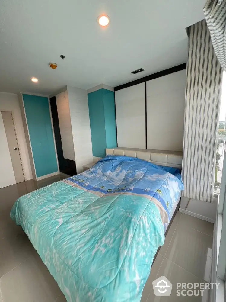 Modern bedroom with large windows and stylish decor in a high-rise apartment.