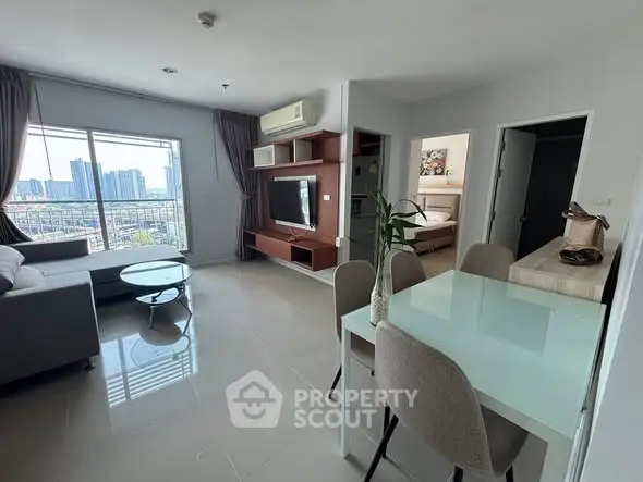 Modern open-plan living room with city view and stylish furniture