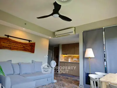 Modern living room with open kitchen and stylish decor in cozy apartment.