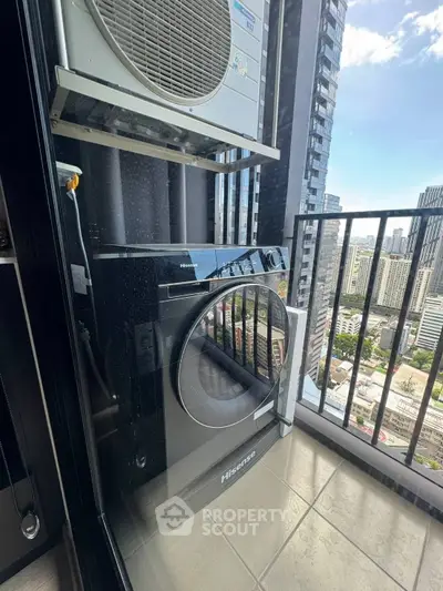 Modern balcony with city view featuring washing machine and air conditioning unit.