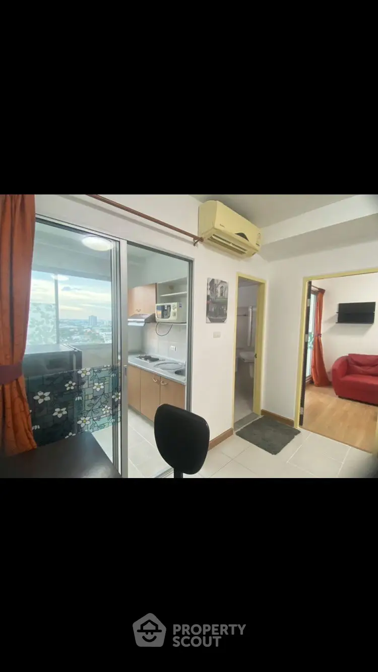 Cozy apartment with compact kitchen and bright living area, featuring modern appliances and city view.