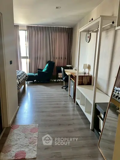 Spacious modern bedroom with stylish decor and ample natural light