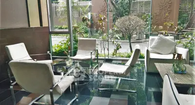 Elegant lobby with modern seating and garden view, perfect for relaxation.