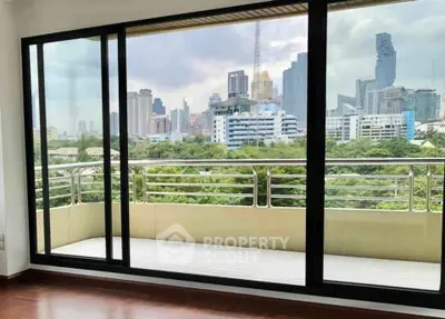 Spacious balcony with stunning city skyline view, perfect for relaxation and enjoying urban living.