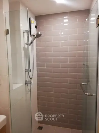Modern bathroom with glass shower enclosure and sleek tile design