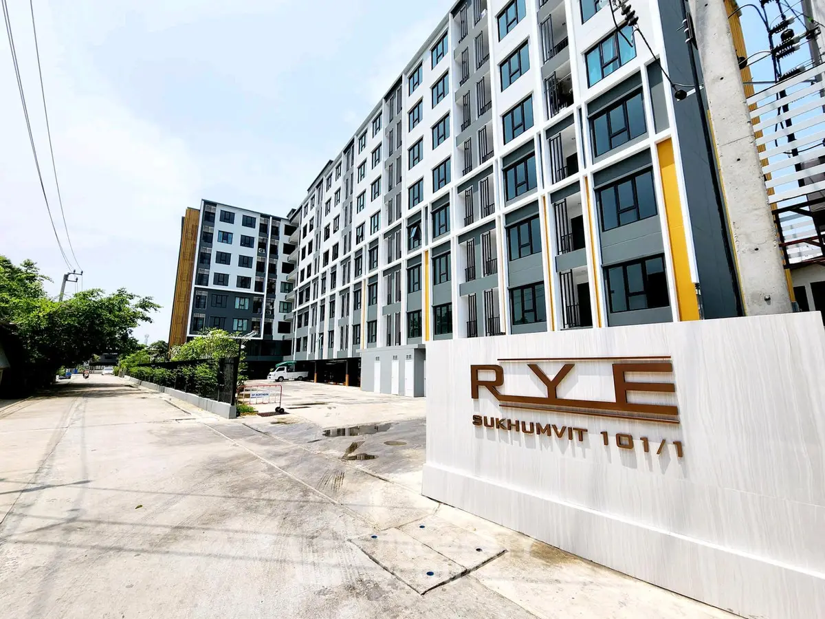 Modern apartment building exterior with sleek design at RYE Sukhumvit 101/1, ideal urban living.