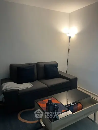 Cozy living room with modern sofa and stylish coffee table, perfect for relaxation.
