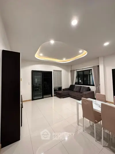 Modern living room with stylish ceiling lights and elegant dining area