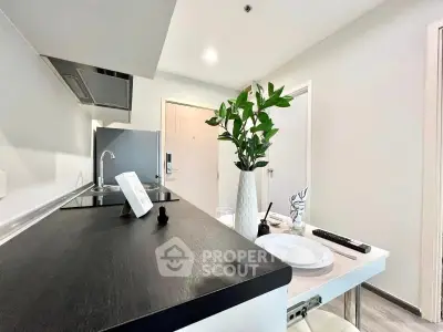 Modern kitchen with sleek design and dining area in stylish apartment