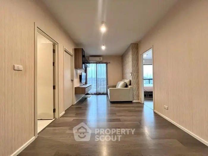 Spacious modern living room with sleek flooring and natural light