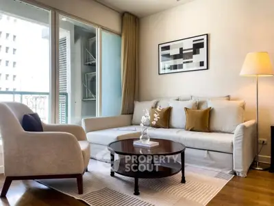 Elegant living room with modern decor and balcony view