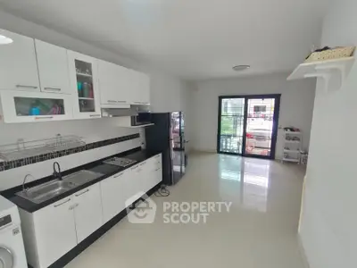 Modern kitchen with sleek white cabinets and spacious layout
