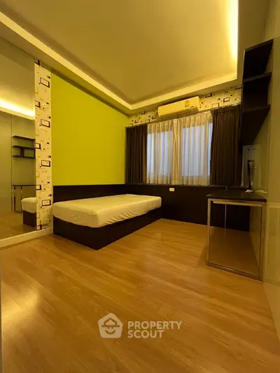 Modern bedroom with stylish decor and wooden flooring