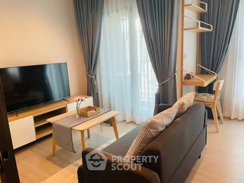 Modern living room with sleek furniture and large windows for natural light.