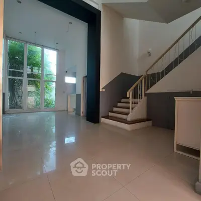 Spacious modern living room with high ceilings and large windows