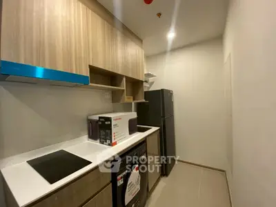 Modern kitchen with sleek cabinetry and appliances in a compact layout