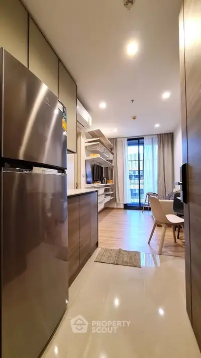 Modern kitchen with open layout and sleek appliances in a stylish apartment