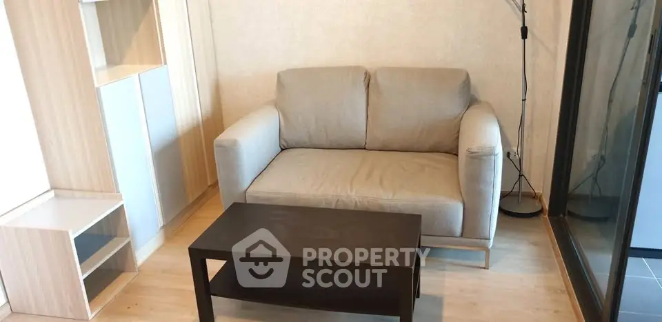 Cozy living room with modern sofa and sleek coffee table in stylish apartment.