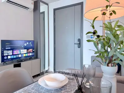 Modern living room with smart TV and stylish decor in a cozy apartment.