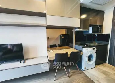 Modern compact kitchen with integrated appliances and stylish dining area