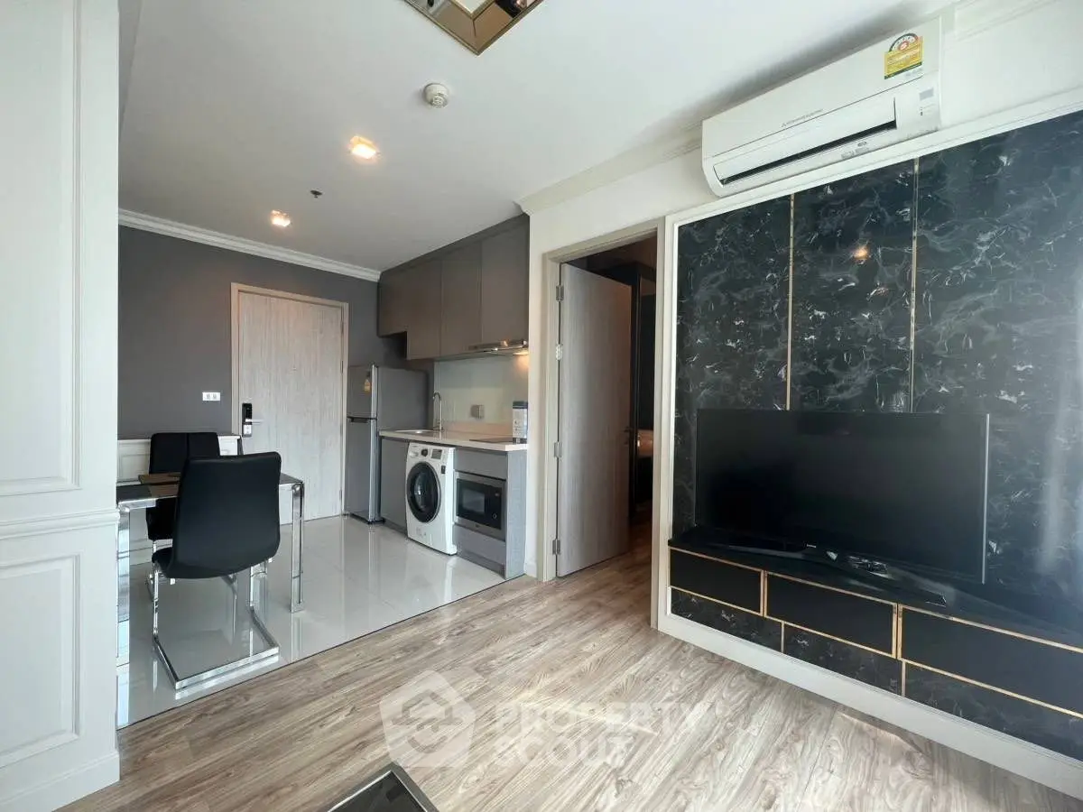 Modern apartment interior with open layout, featuring sleek kitchen and cozy living area.
