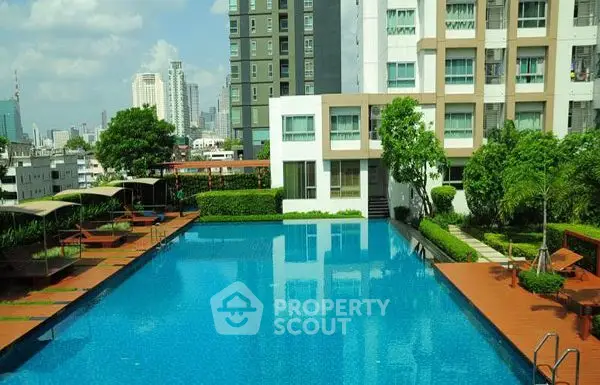 Luxurious urban apartment complex with stunning outdoor pool and city views.