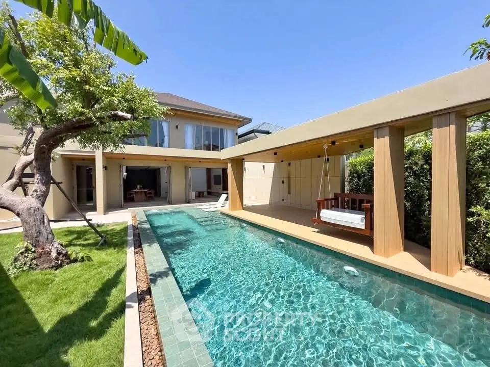 Luxurious modern home with private pool and lush garden, perfect for relaxation and entertainment.