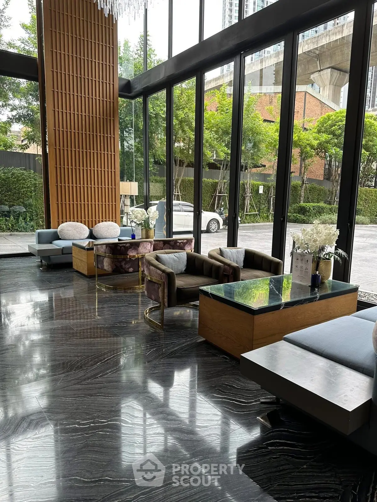 Luxurious lobby with modern furniture and floor-to-ceiling windows offering a stunning view.