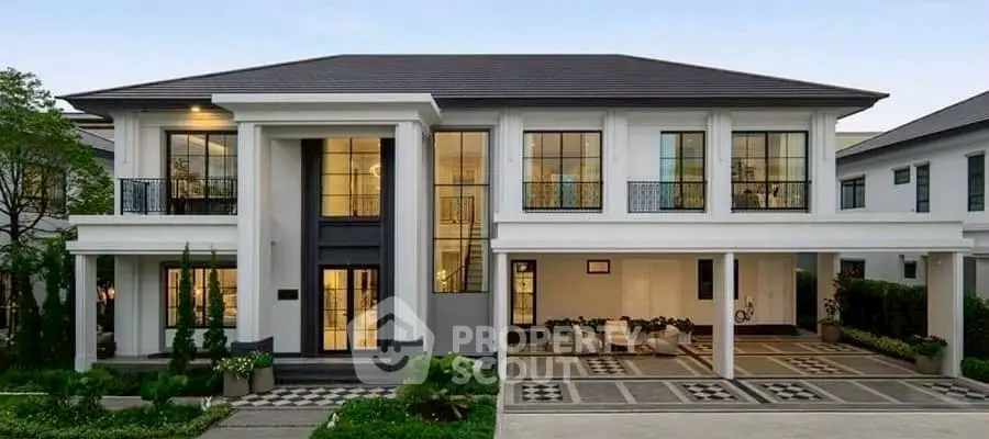 Luxurious two-story modern house with elegant facade and spacious driveway.