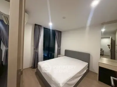 Modern bedroom with large bed and stylish curtains in a contemporary apartment.