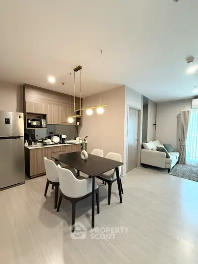 Modern open-plan living and dining area with stylish furniture and contemporary lighting