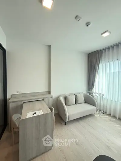 Modern living room with stylish furniture and large window for natural light.