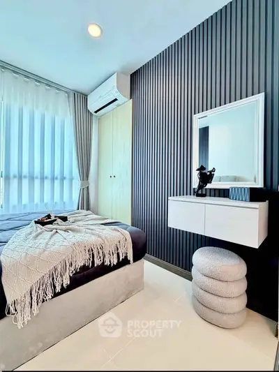 Modern bedroom with sleek design, featuring a cozy bed, stylish decor, and ample natural light.