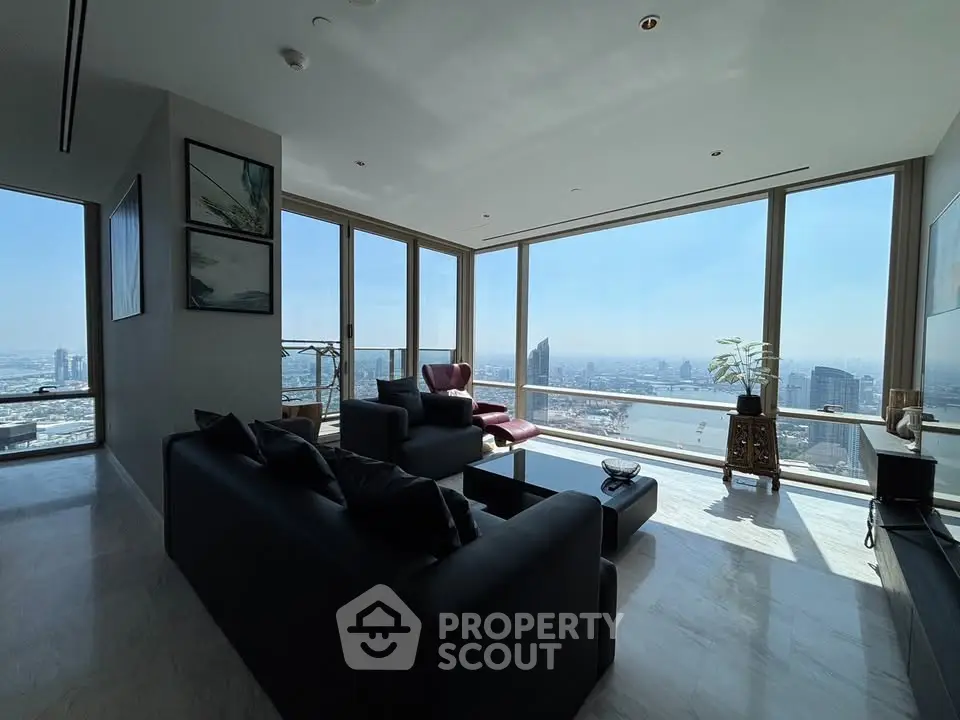 Luxurious living room with panoramic city views and modern furnishings.