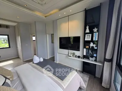 Luxurious modern bedroom with stylish decor and large windows offering natural light.