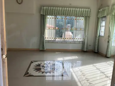 Spacious living room with large windows and decorative tile flooring